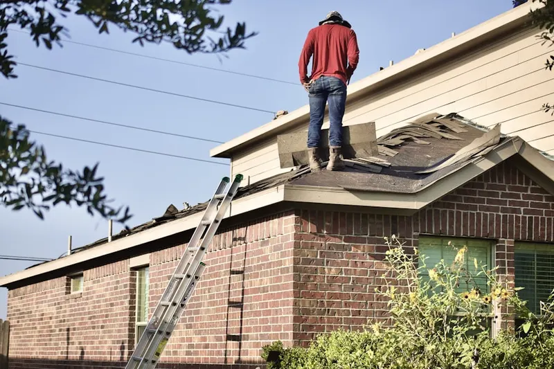 Professional roofer working on a residential roof in Shenorock